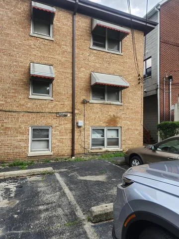 a view of a room with wooden floor and cabinet