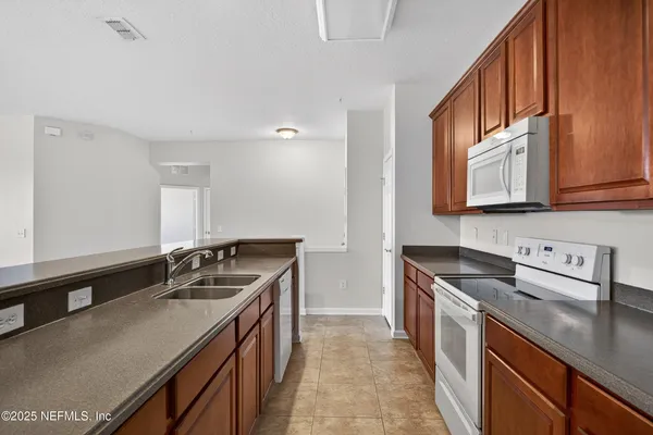a kitchen with stainless steel appliances granite countertop a sink stove and cabinets