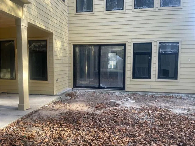 a living room with stainless steel appliances kitchen island granite countertop furniture and a rug