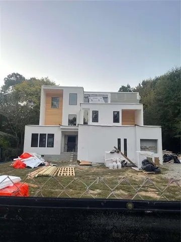 a view of a white house with a yard