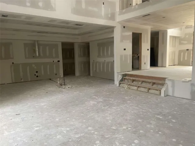 a spacious bedroom with a bed and a window