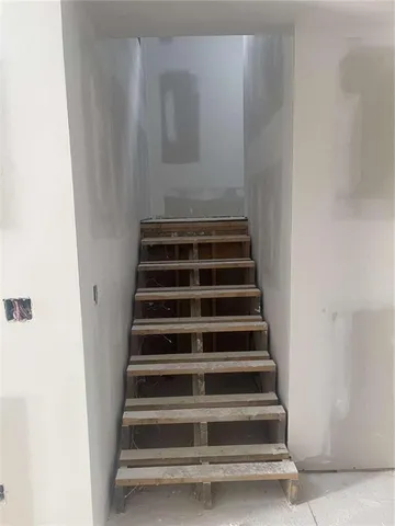 a bedroom with a bed window and flat screen tv