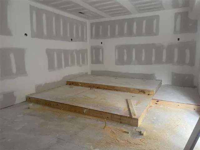 a view of a two chairs and table in a big yard