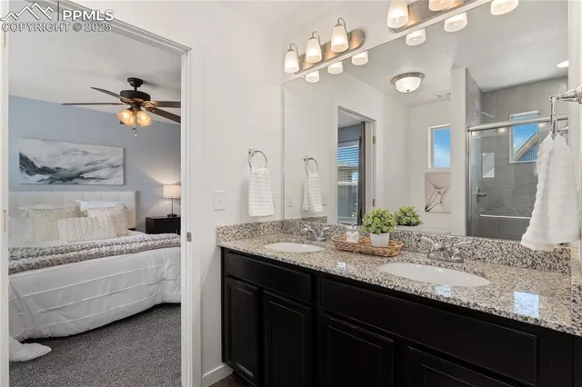 a bathroom with a granite countertop sink a toilet and a mirror