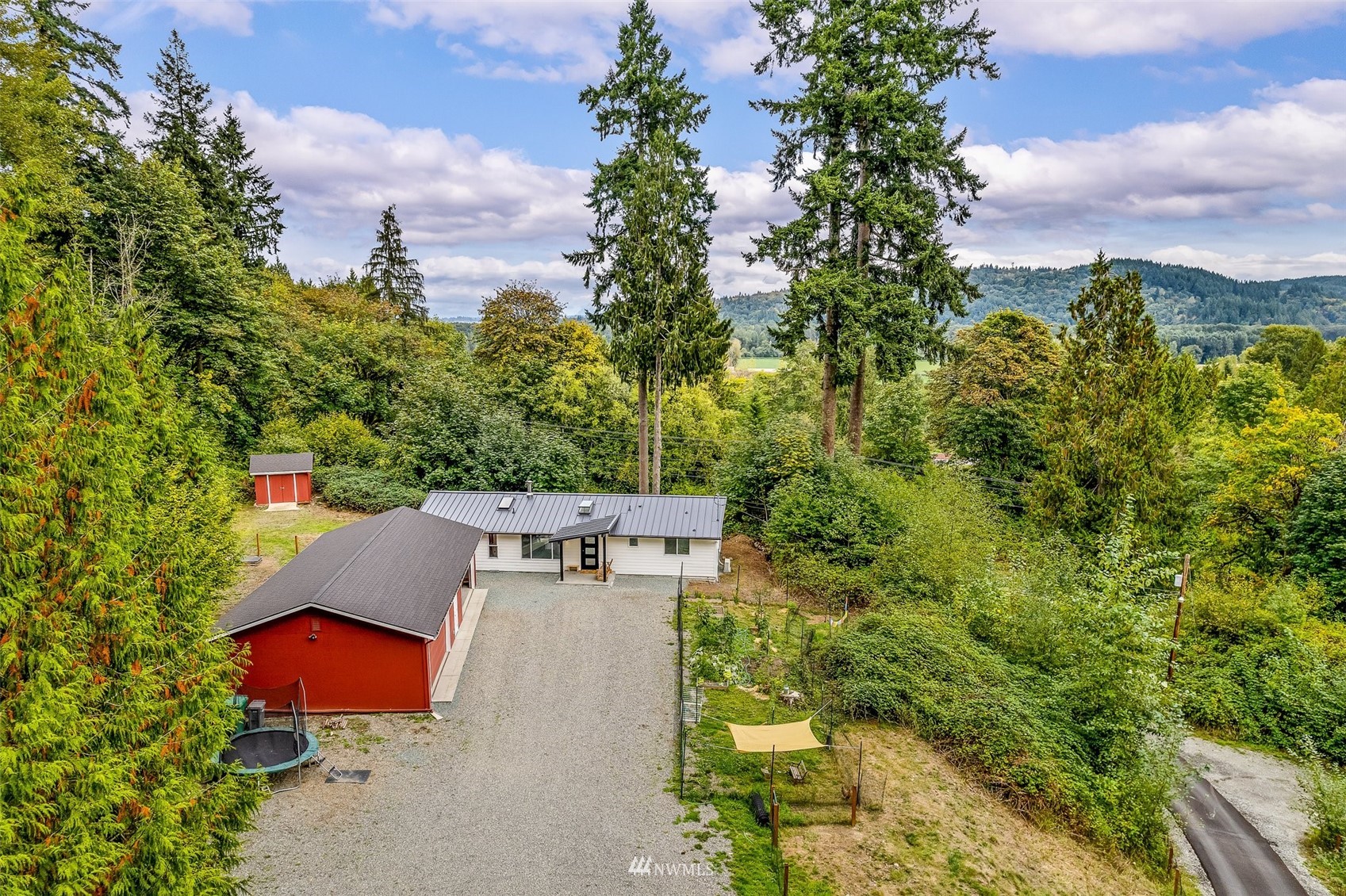 10302 Elliott Road Snohomish, WA 98296 - Photo 1 of 24 an aerial view of residential house with outdoor space and trees all around