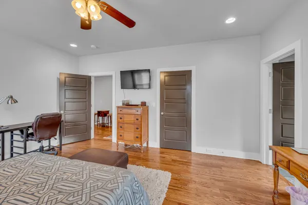 a bedroom with furniture and a chair