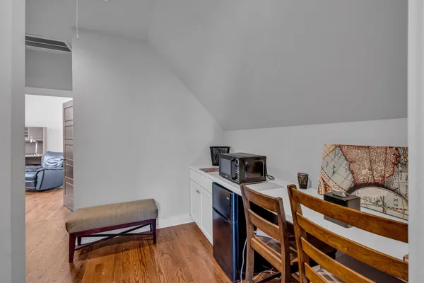 a view of a workspace with furniture and wooden floor