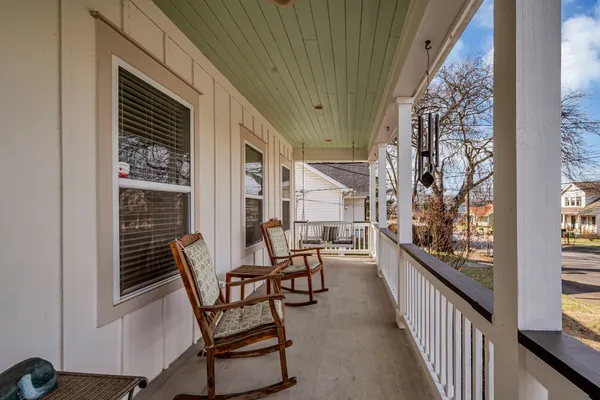 a view of a balcony with chairs