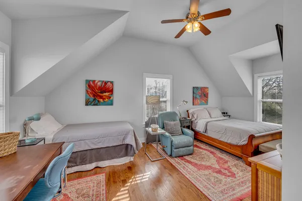 a bedroom with furniture and a chandelier