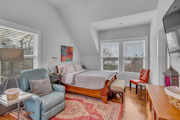 a bedroom with furniture and a large window