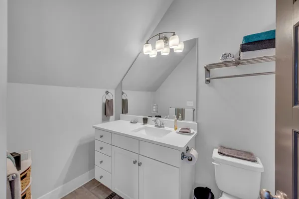 a bathroom with a sink vanity and a mirror