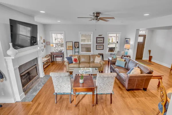 a living room with fireplace furniture and a flat screen tv