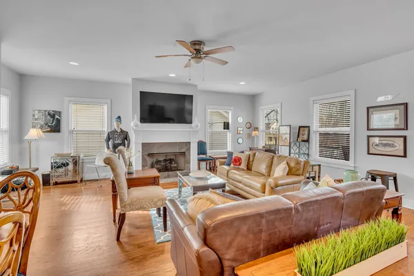 a living room with fireplace furniture and a flat screen tv