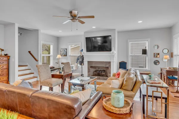 a living room with fireplace furniture and a flat screen tv