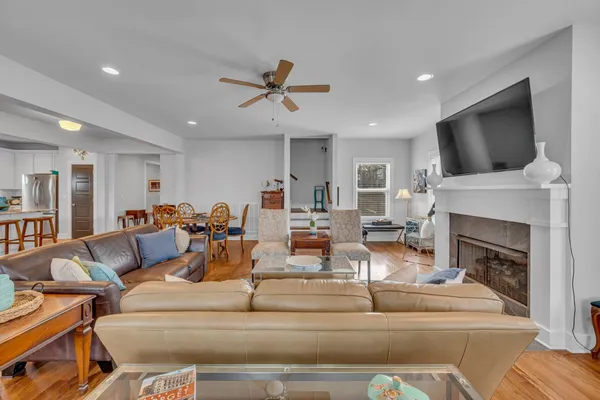 a living room with furniture a flat screen tv and a fireplace