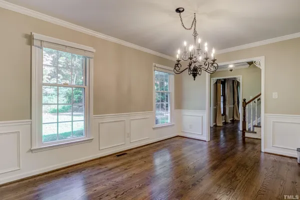 a view of a room with wooden floor