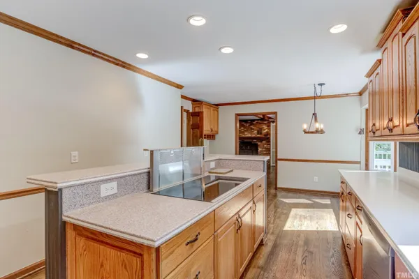a kitchen with stainless steel appliances granite countertop a sink and a refrigerator