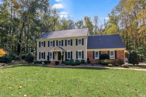 a front view of a house with a yard table and chairs