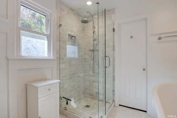 a bathroom with a shower and a sink