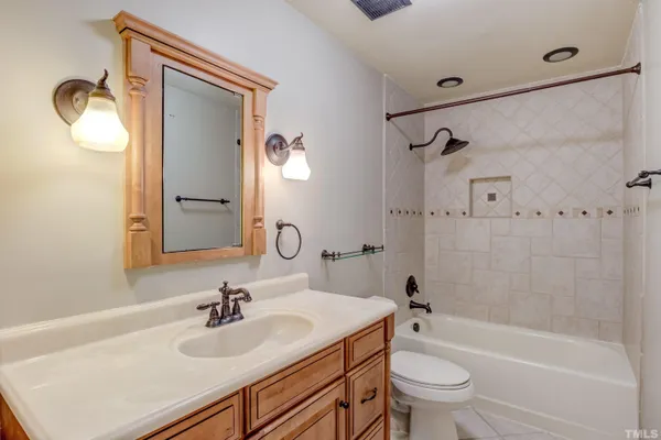 a bathroom with a sink toilet tub and shower