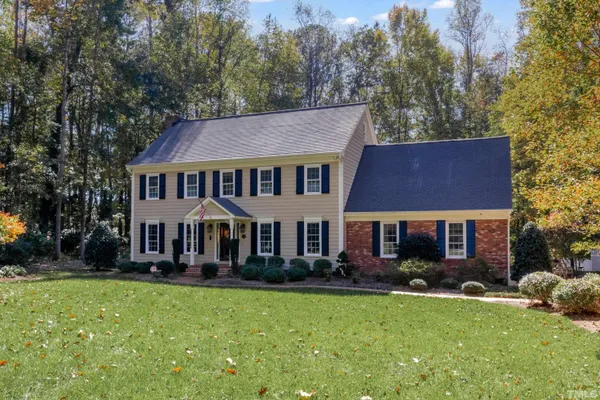 a front view of a house with a yard table and chairs