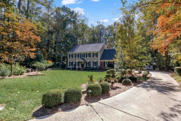 a view of a house with backyard and sitting area