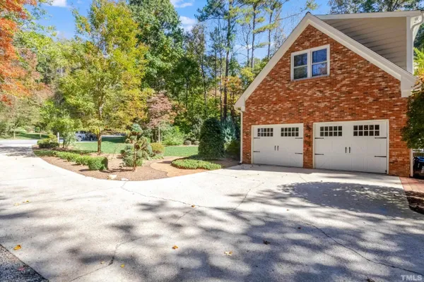 a view of a house with a yard and garage