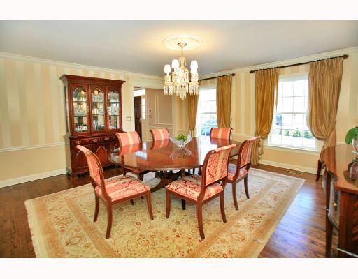 Undisclosed Address Darien, CT 06820 - Photo 4 of 16 a dining room with wooden floor a chandelier a glass table and chairs
