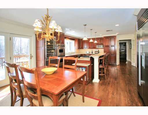 Undisclosed Address Darien, CT 06820 - Photo 7 of 16 a view of a dining room with furniture a chandelier and wooden floor