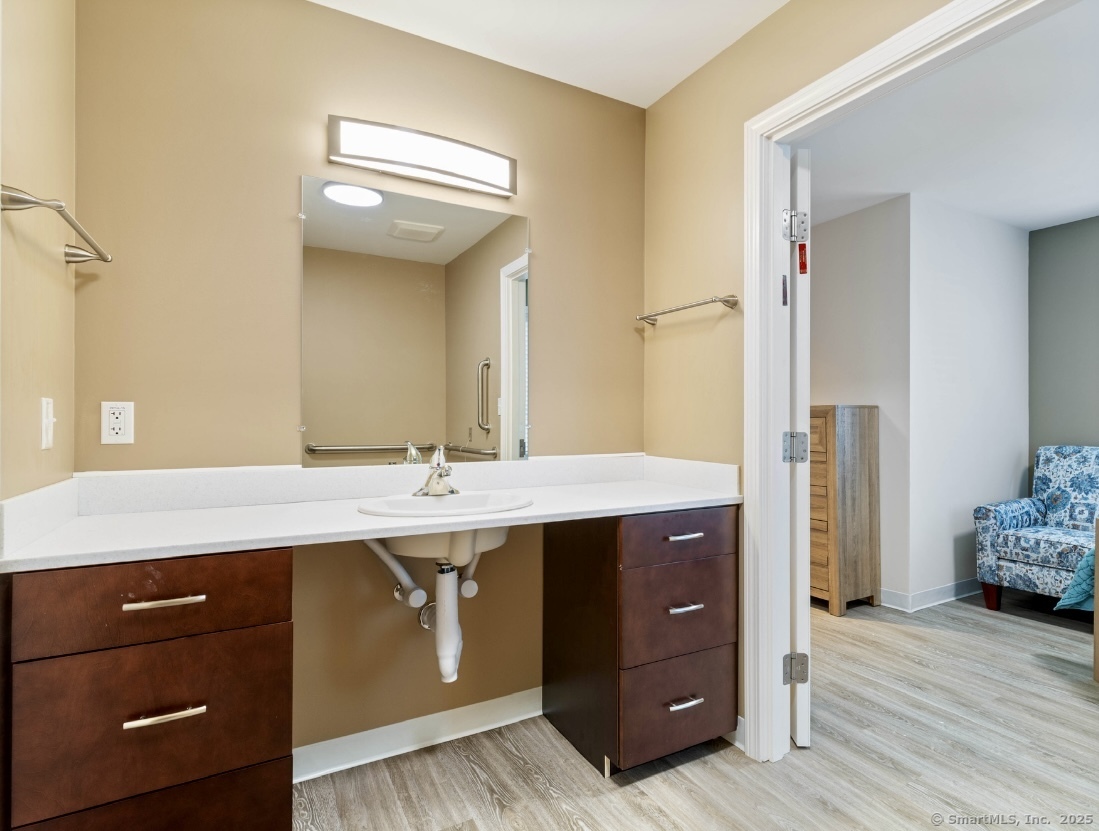 14 Godfrey Street Groton, CT 06355 - Photo 14 of 20 a spacious bathroom with a granite countertop sink and a mirror
