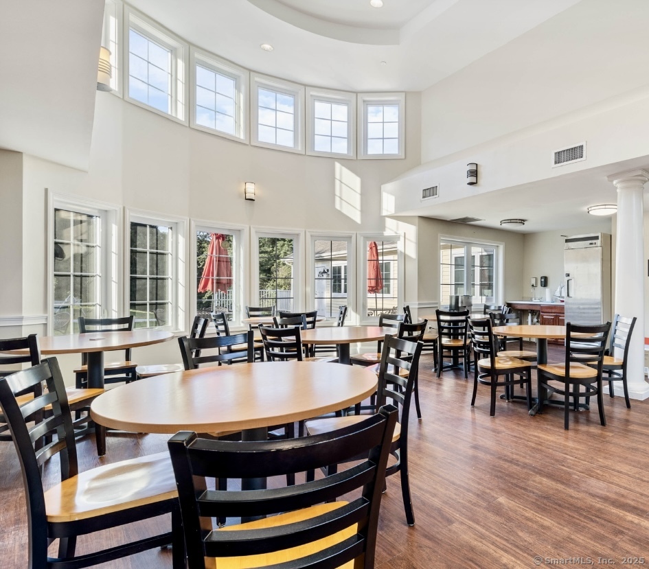14 Godfrey Street Groton, CT 06355 - Photo 2 of 20 a dining room with wooden floor and large windows
