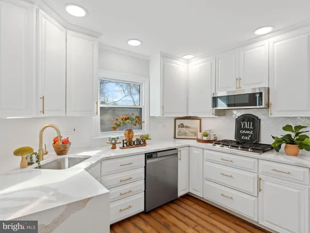a kitchen with a refrigerator and a stove top oven