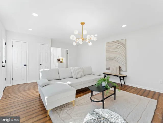 a spacious bedroom with a large bed and a chandelier