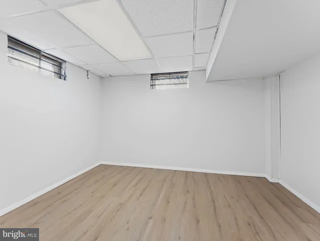 an aerial view of a house with swimming pool and large trees