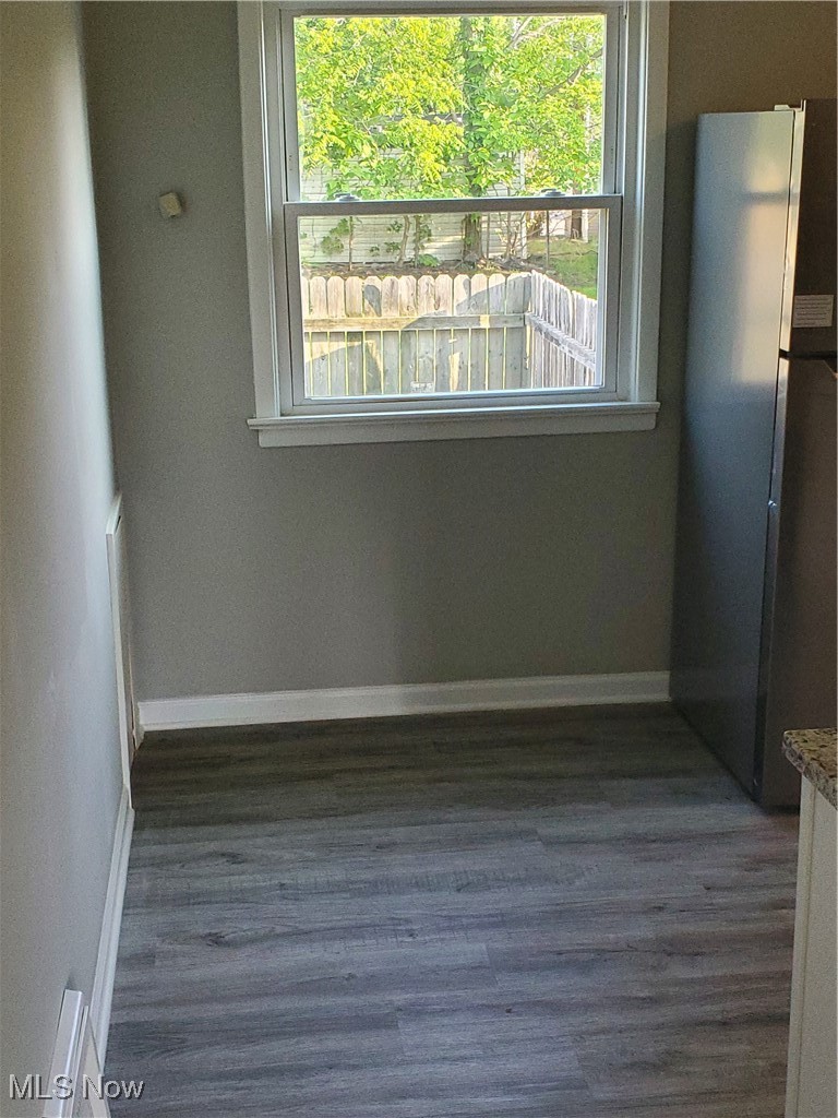 7007 Biddulph Road Brooklyn, OH 44144 - Photo 5 of 16 Unfurnished dining area featuring plenty of natural light, dark wood finished floors, and baseboards