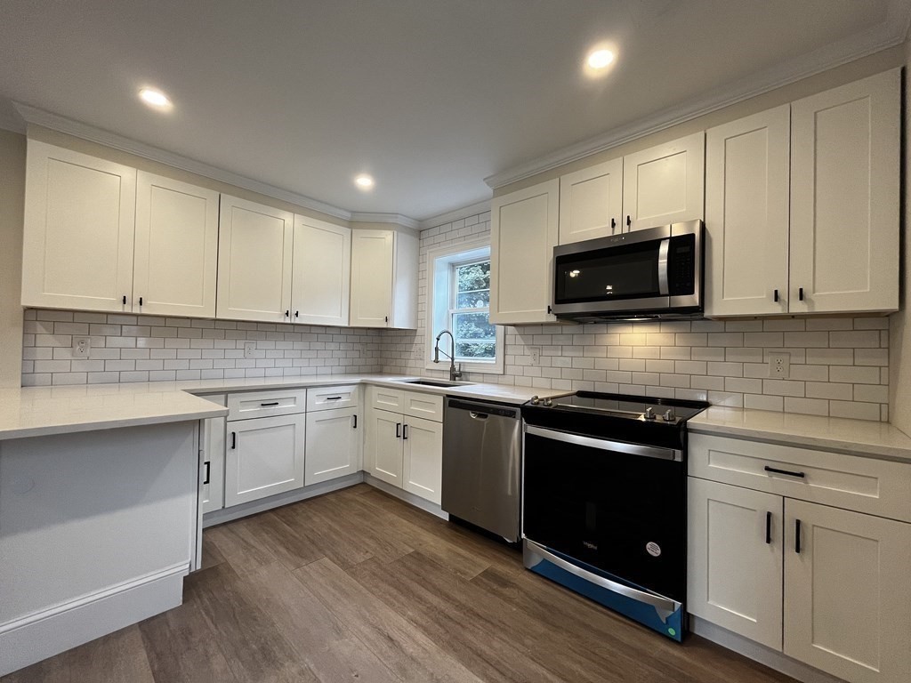 a kitchen with granite countertop cabinets and steel stainless steel appliances