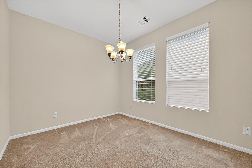 3218 Dappled Vale Trail Spring, TX 77373 - Photo 14 of 47 en empty room with windows and chandelier