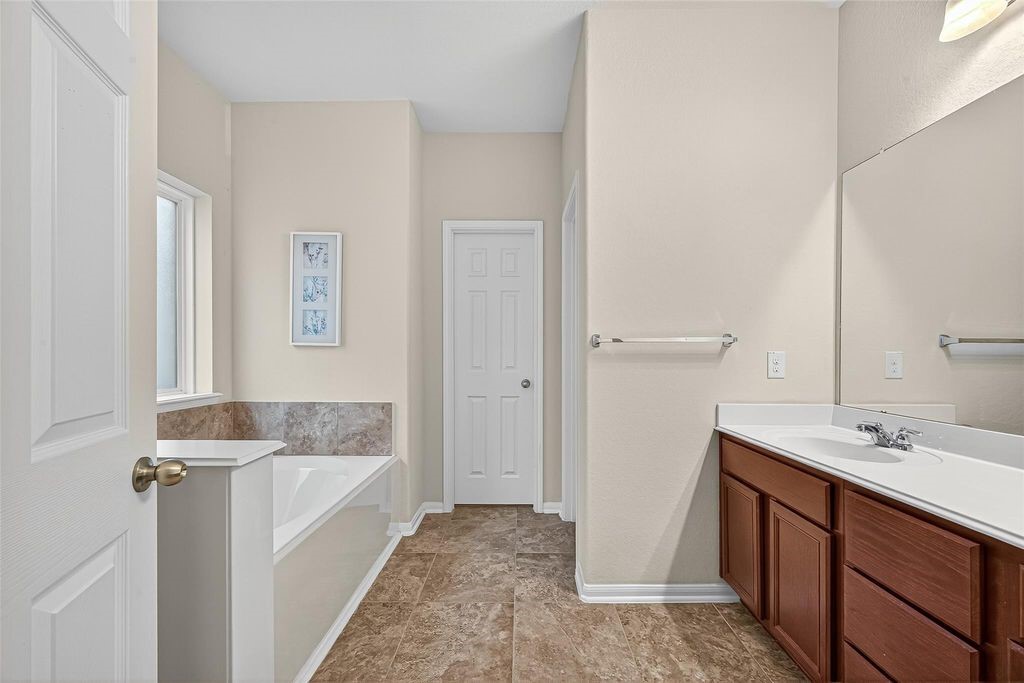 3218 Dappled Vale Trail Spring, TX 77373 - Photo 26 of 47 a bathroom with a tub sink and mirror