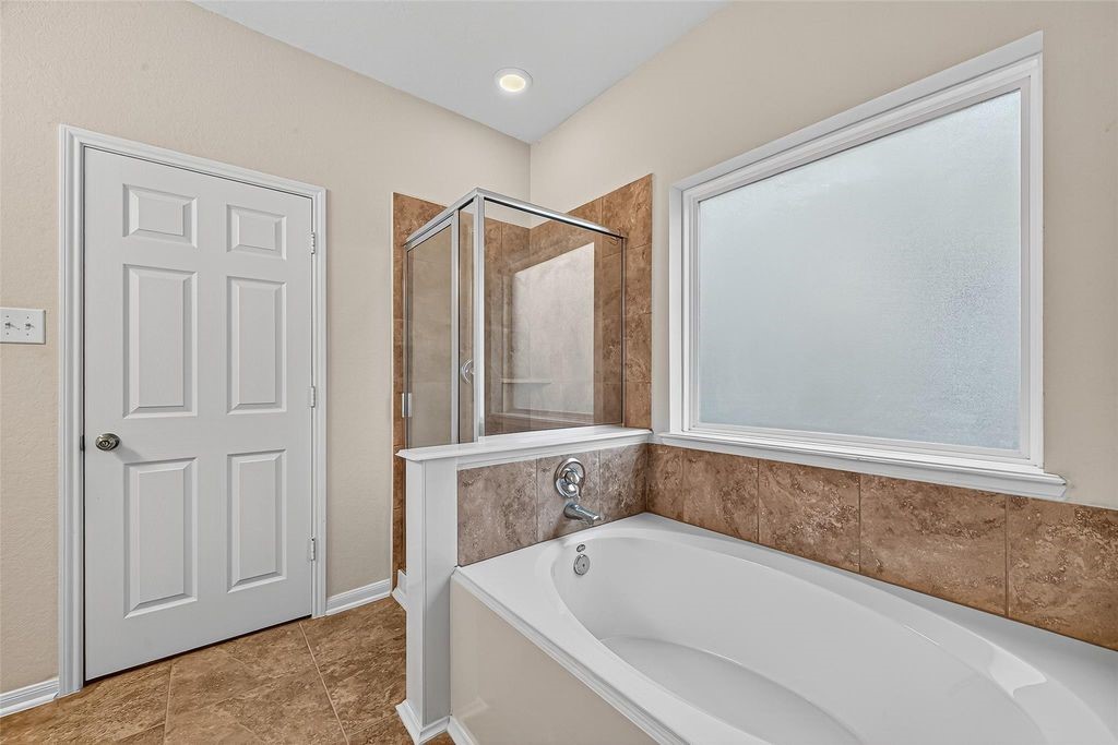 3218 Dappled Vale Trail Spring, TX 77373 - Photo 27 of 47 a bathroom with a bathtub and shower