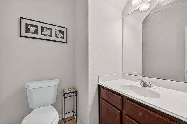 a bathroom with a toilet a sink and mirror