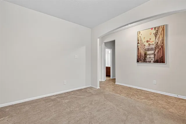 a view of an empty room with painting on the wall