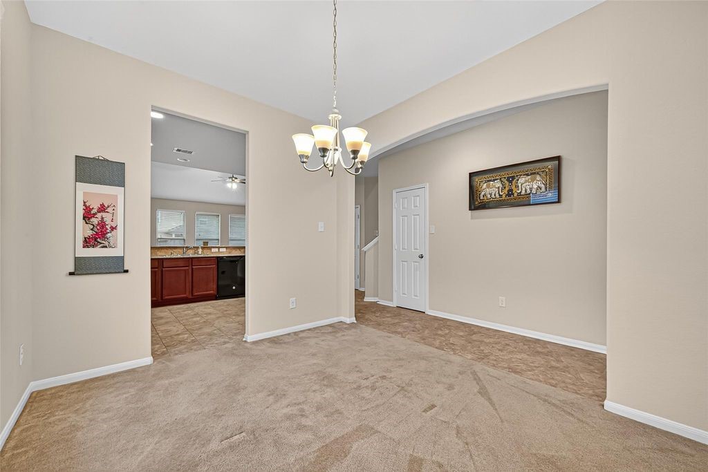 3218 Dappled Vale Trail Spring, TX 77373 - Photo 10 of 47 a view of a hallway with cabinet and a chandelier