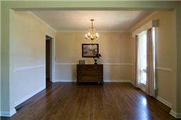 Dining Room is at one end of the Living Room and Dining Room combination, just freshly painted and has a pretty fixture and window