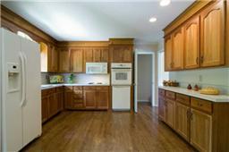 This Kitchen was redone a few years ago - cabinets look nice but adding granite would make them look awesome - seller has added new hardwood and the floors are beautiful