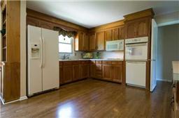Different angle of the kitchen and a great view of the back yard from the kitchen sink