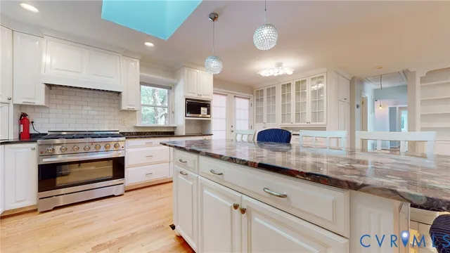 a kitchen with stainless steel appliances granite countertop a stove and a sink