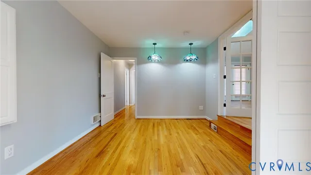 a view of a room with wooden floor