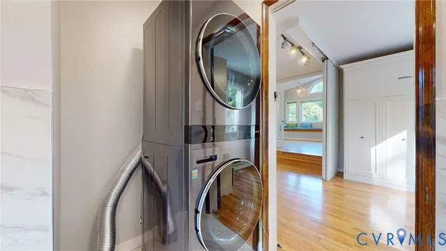 a view of a bathroom with washing machine and a mirror