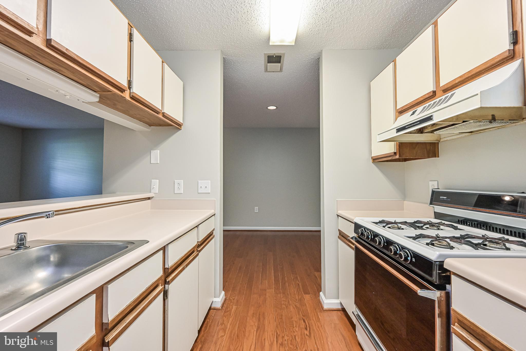 20952 Timber Ridge Terrace, Unit 103 Ashburn, VA 20147 - Photo 13 of 24 view from kitchen to dining room