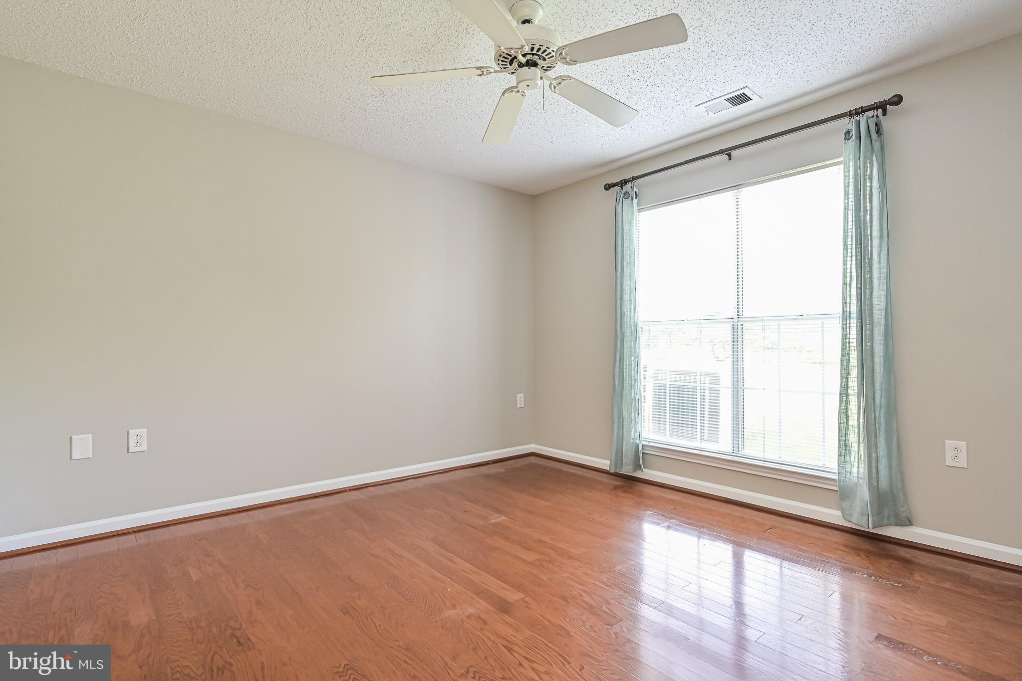 20952 Timber Ridge Terrace, Unit 103 Ashburn, VA 20147 - Photo 14 of 24 Brilliant hardwood floors in this spacious bedroom